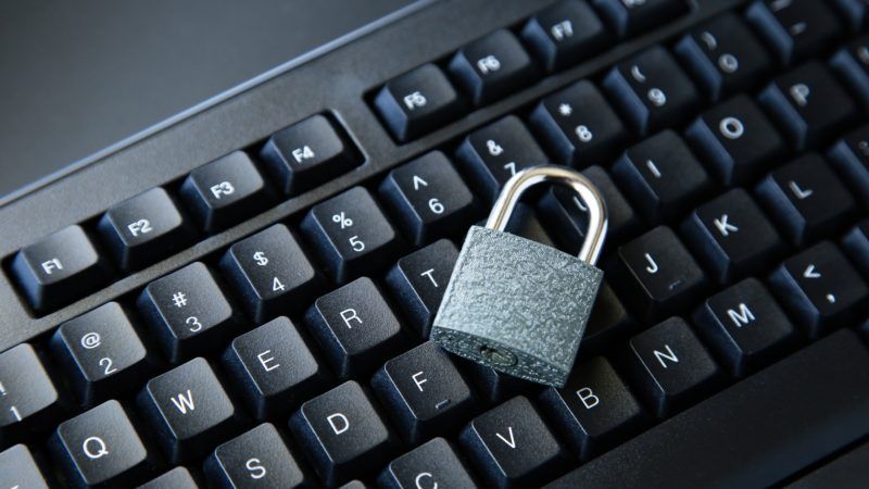 high angle shot of a lock on a black computer keyboard on a black surface 800x450 1